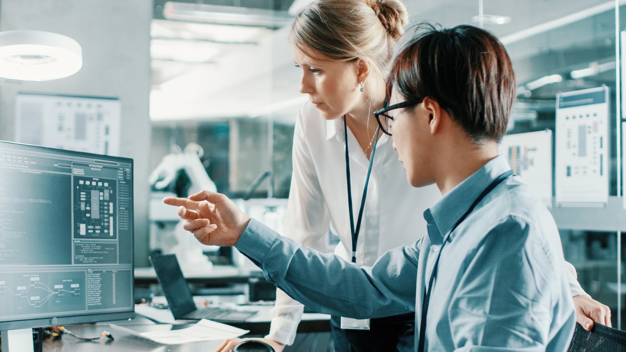 Professionals collaborating on digital solutions and data insights in a regulated life sciences environment.